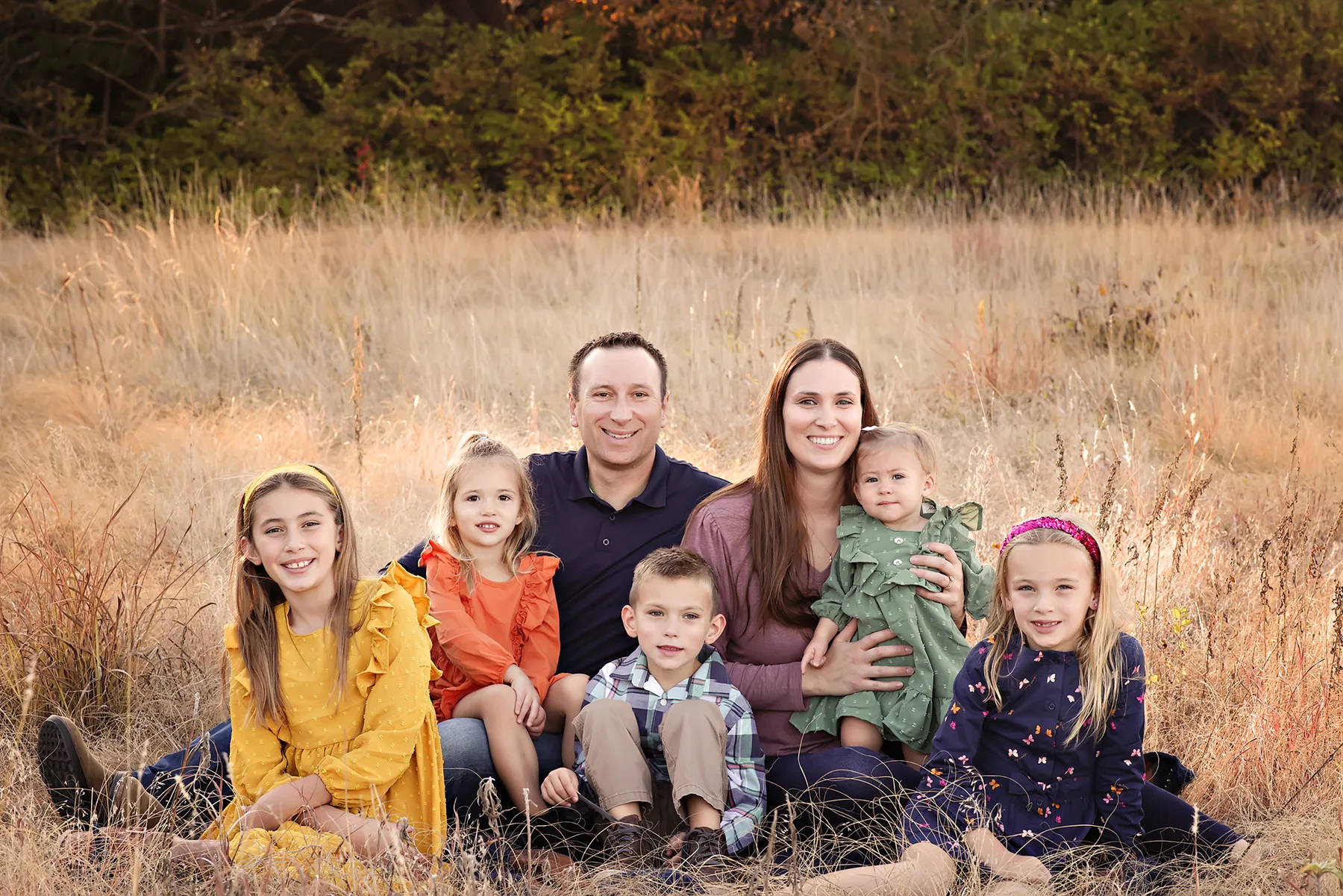 Family enjoying a sunset portrait overlooking the countryside