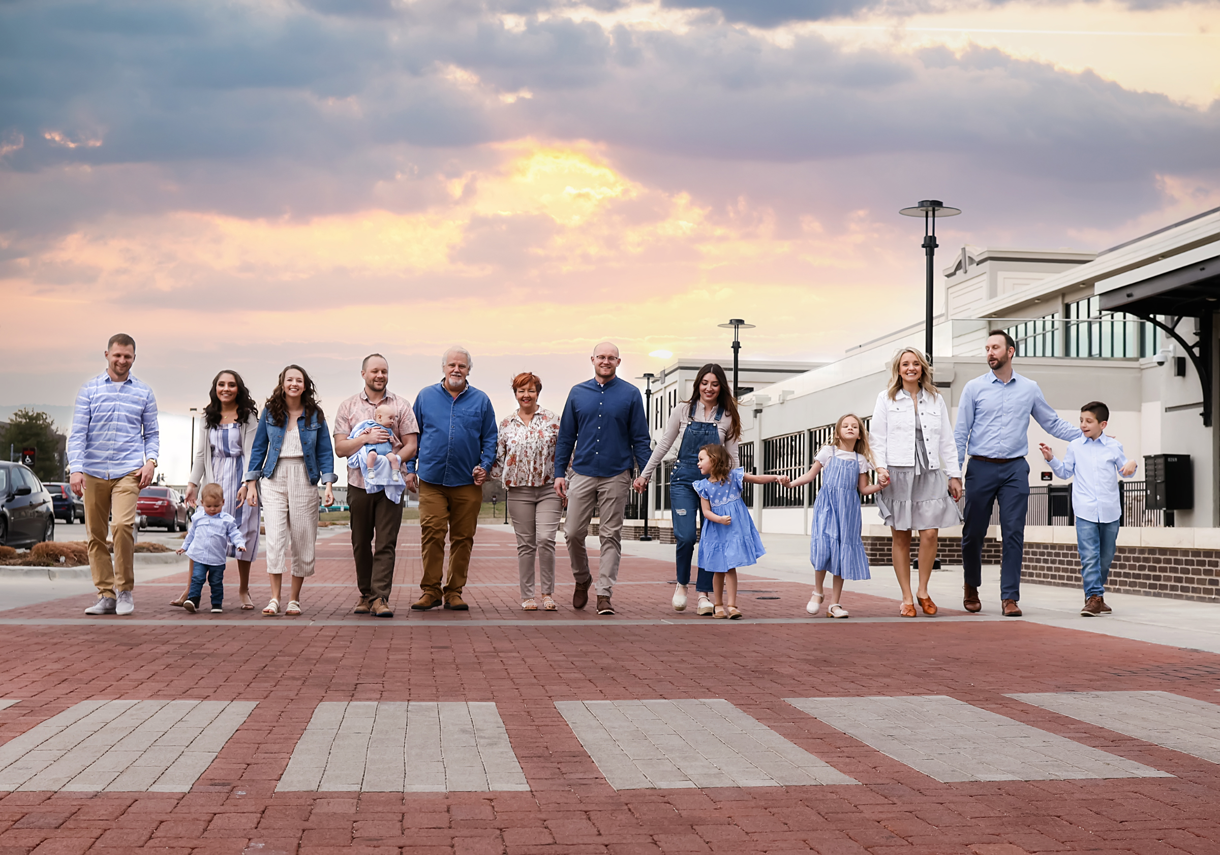 Multigenerational family walking together at sunset during an extended family photography session in Wichita, Kansas